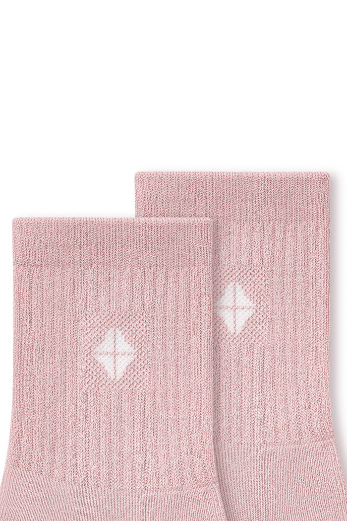 Close up of adult Crew Socks in Blush laying flat on a white background.