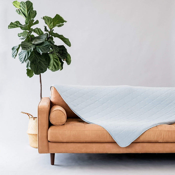 Couch with Kyte Baby Adult Quilted bamboo Blanket in Fog