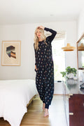 Model posing in Adult Sleeveless Sleep Bag Walker in Midnight Wildflower print in bedroom