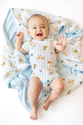 Smiling infant laying on a Baby Blanket in Amalfi Coast 1.0 wearing the matching short sleeve bodysuit