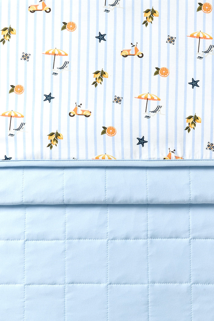 Close up of the Baby Blanket in Amalfi Coast 1.0 showing the quilted light blue backing and smooth top printed layer