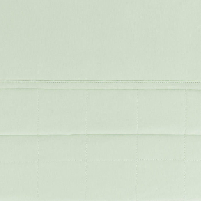 Close up of the quilted bottom and smooth top layer on the Baby Blanket in Basil 1.0