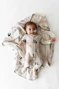 Smiling infant laying on a Baby Blanket in Fluffy Cat wearing a matching zippered footie