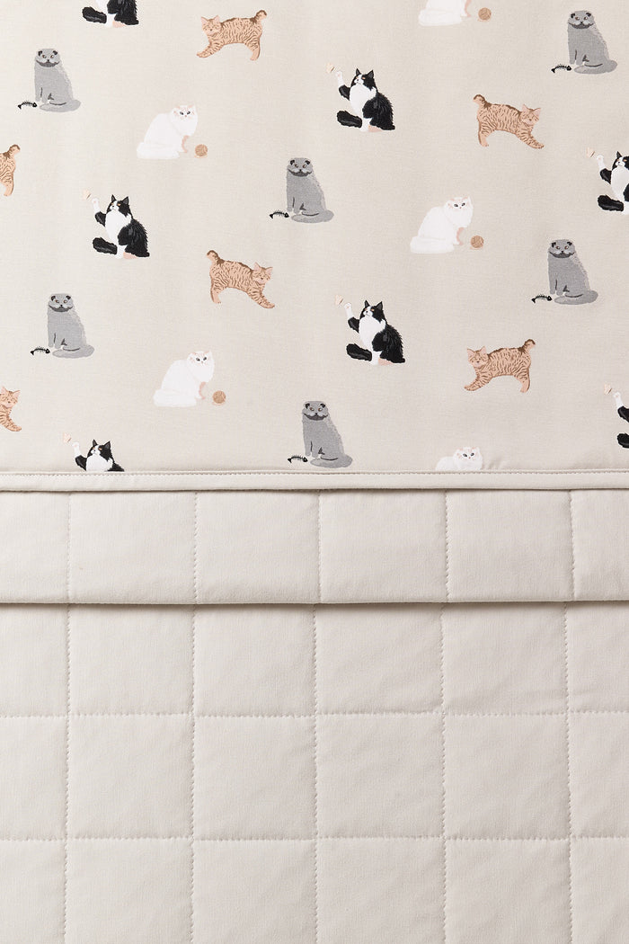Close up of the Baby Blanket in Fluffy Cat showing the light beige quilted backing and smooth top layer cat print
