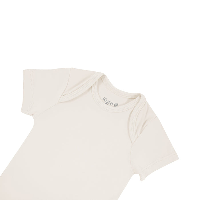 Close up of top area of Kyte Baby short sleeve Bodysuit in Oat
