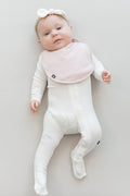 Infant wearing Kyte Baby Cushy Bib in Blush