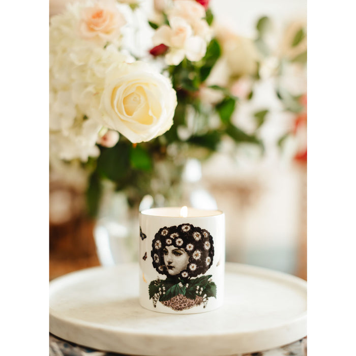 Eden ceramic candle lit, showing the warm glow of the flame in the fine china vessel