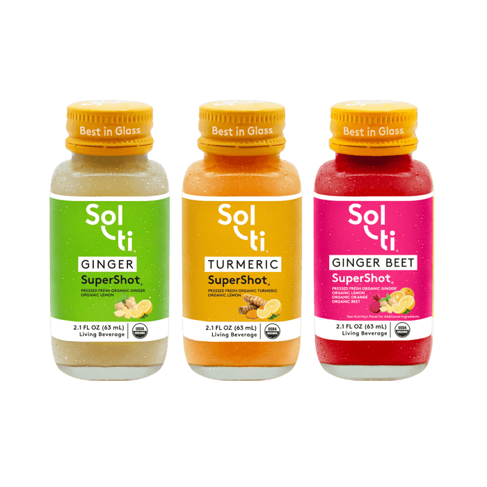 Three Sol-ti SuperShot glass bottles: GINGER, TURMERIC, and GINGER BEET