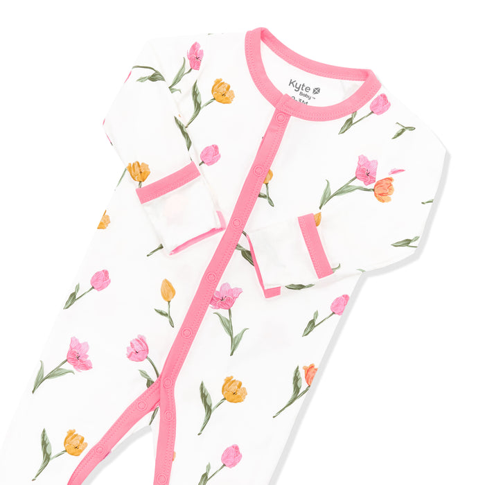 Snap closure with pink trim and fold over hand cuffs shown on the Footie in Tulip