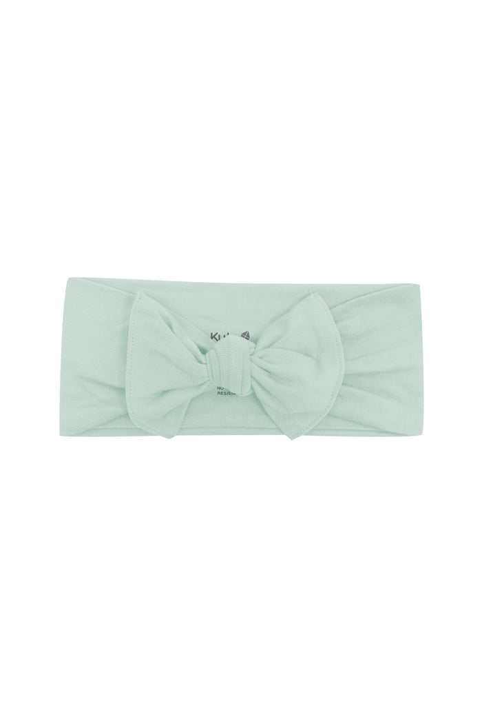 Flat lay of Kyte Baby Bow in Sage