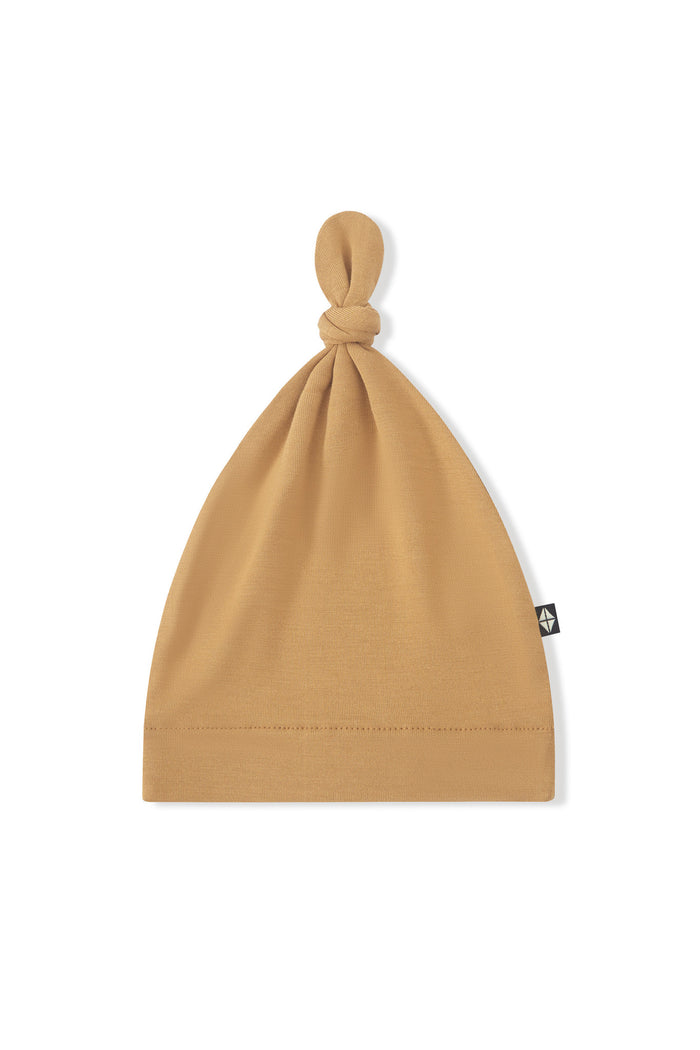 Knotted Cap in Ochre on a white background