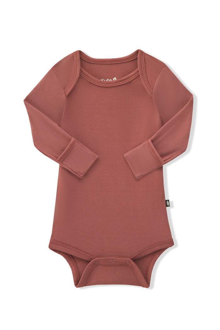 Arms of the Long Sleeve Bodysuit in Ember folded inward showing the fold over hand cuffs on a white background