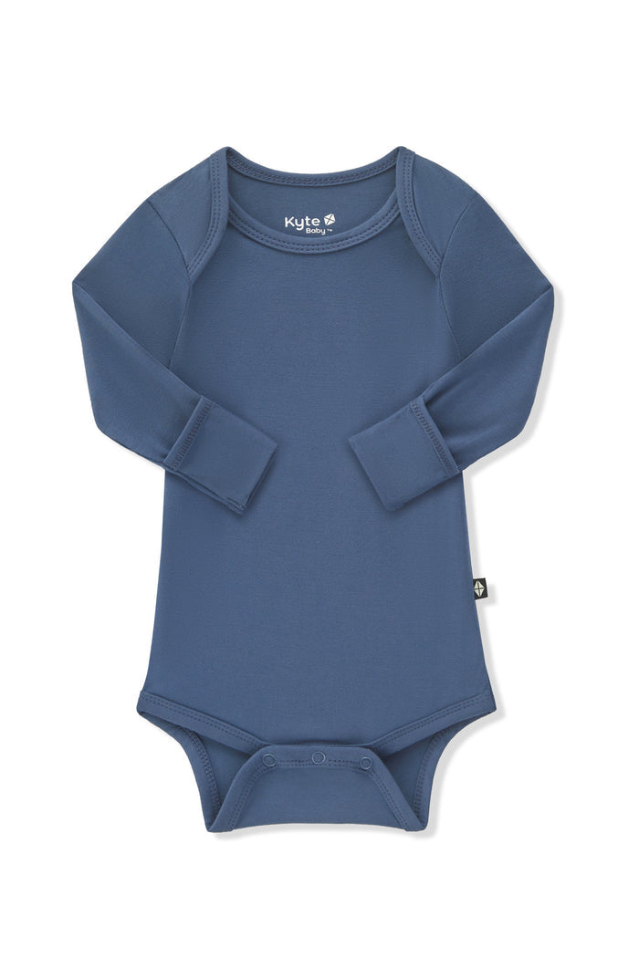 Arms of the Long Sleeve Bodysuit in Oxford folded inward showing the fold over hand cuffs on a white background