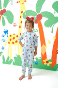 Girl posing in Long Sleeve Jogger Set in Curious George print standing in front of a colorful background