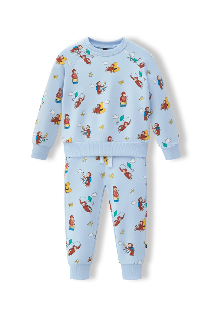 A two-piece kids' sweatshirt and jogger pants set in light blue, featuring an all-over cartoon monkey print, displayed on a clean white background.