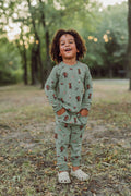Boy outside with his hands in his pocket wearing groot jogger set.