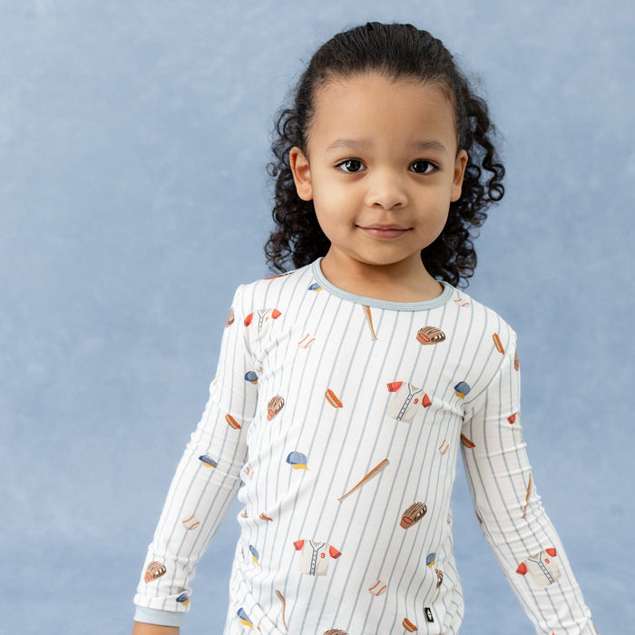 Close up of young girl wearing the Long Sleeve Pajamas in Home Run