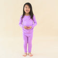toddler modeling long sleeve pajamas in poi