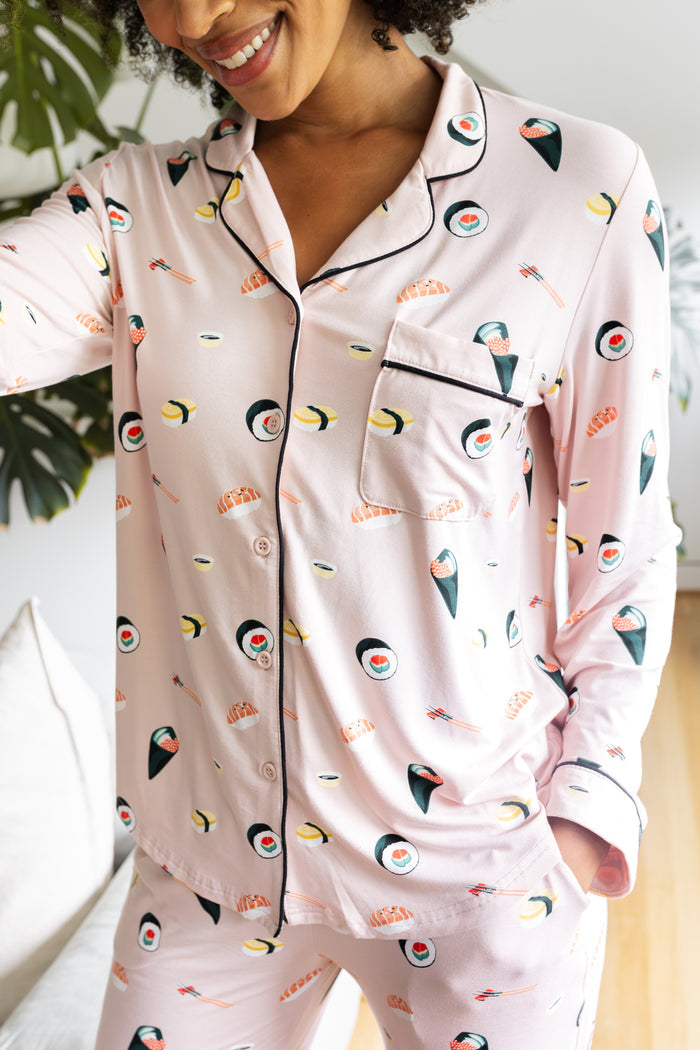 Person wearing a pink pajama set with sushi pattern