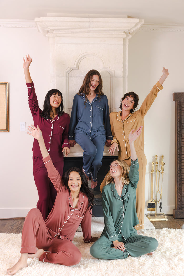 5 modals wearing Long-Sleeved Women's Pajama Set in Burgundy, pine, oxford, ochre and ember posing in a living room