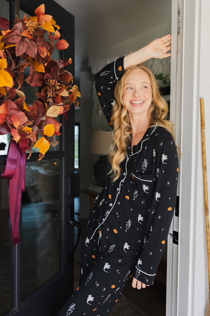 Modal smiling in door way wearing Long-Sleeved Women's Pajama Set in Halloween Friends print