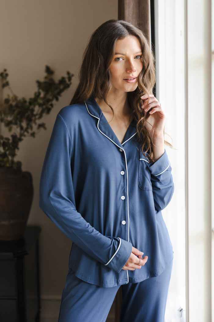 Modal posing in Long-Sleeved Women's Pajama Set in Oxford standing against a large window