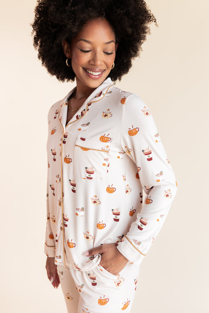 Model posing in Long-Sleeved Women's Pajama Set with Pumpkin Spice Latte print on a beige background