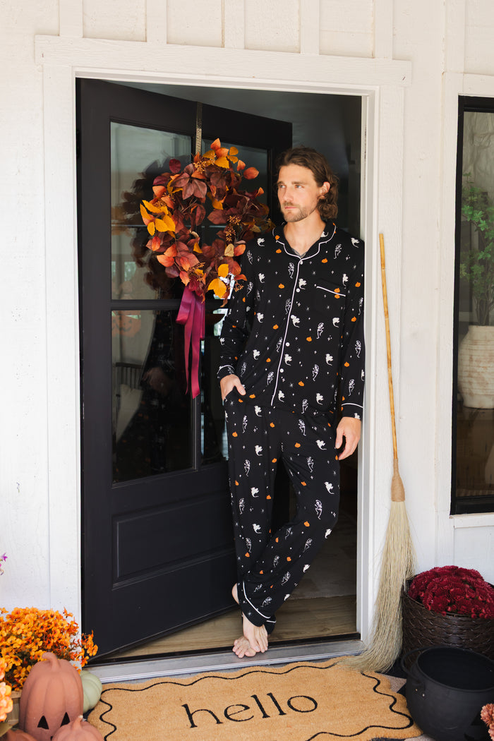Model posing in Men's Long Sleeve Pajama Set in Halloween Friends print standing in doorway