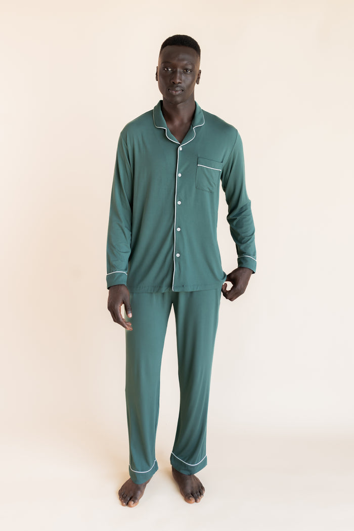 Model wearing Men's Long Sleeve Pajama Set in Pine on a beige background