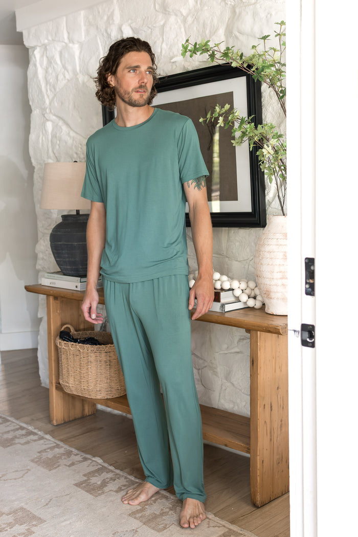 Model wearing Men's Crew Neck Tee in Pine over Men's lounge pants in Pine
