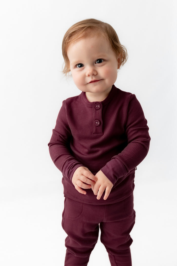 Toddler posing in Ribbed Infant Henley Set in Burgundy on a white background