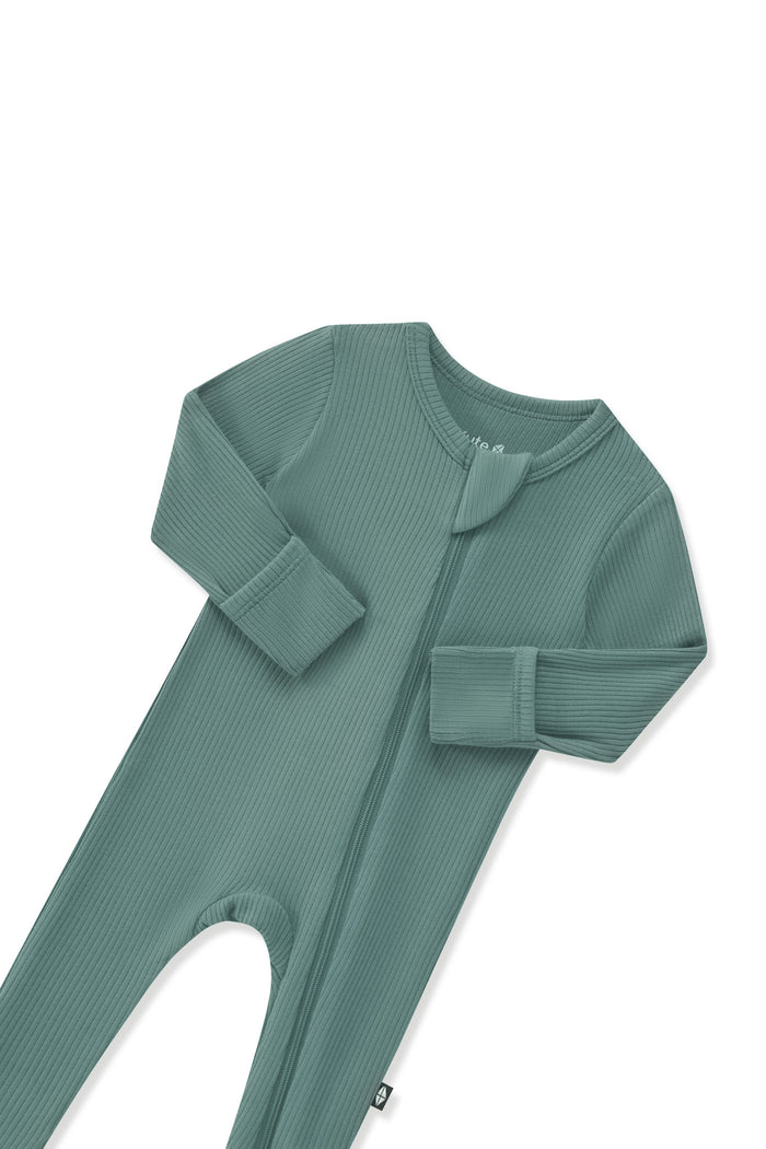 Close up of the zipper garage and fold over hand cuffs on the Ribbed Zipper Footie in Pine on a white background