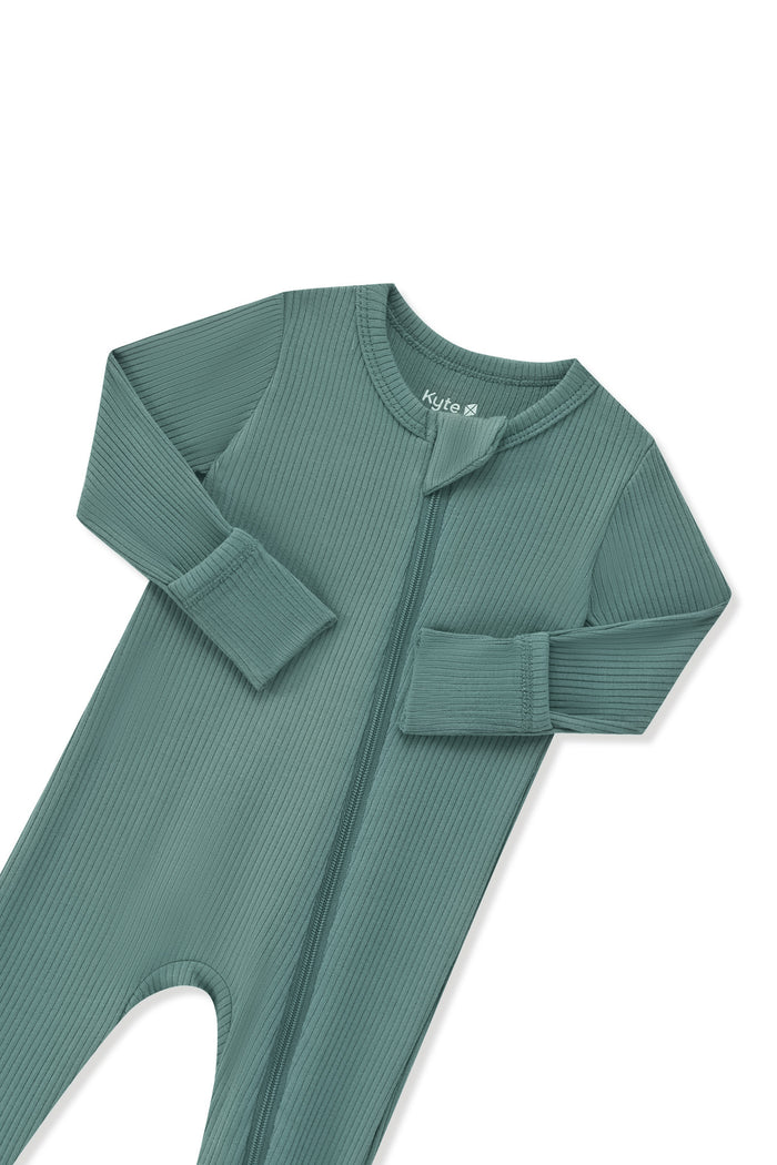 Zipper garage and fold over hand cuffs shown on the Ribbed Zipper Romper in Pine on a white background