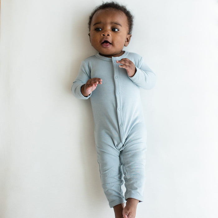 Infant wearing Kyte Baby Romper in Fog