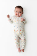 Baby wearing a snap romper in a mickey head pattern
