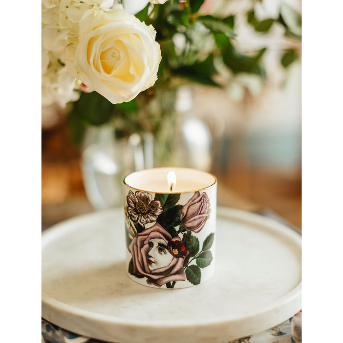 Rosa ceramic candle lit, showing the warm glow of the flame in the fine china vessel