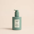 Green shampoo and body wash bottle with Kyte Skin label on a beige background
