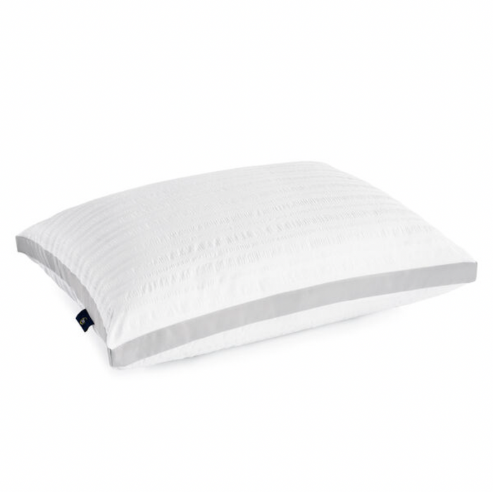 The Serta Dream Loft Pillow by Keeco is a rectangular white pillow featuring a textured, striped surface made from super soft seersucker fabric, paired with smooth fabric edges. Filled with plush, hypoallergenic SupraLoft premium fiber for ultimate comfort, it includes a tag on one corner. The plain white background highlights its clean design and contours perfectly.