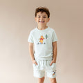 Young boy modeling the Short Sleeve Jogger Set in Winnie the Pooh on Dew with the hands in the shorts pockets