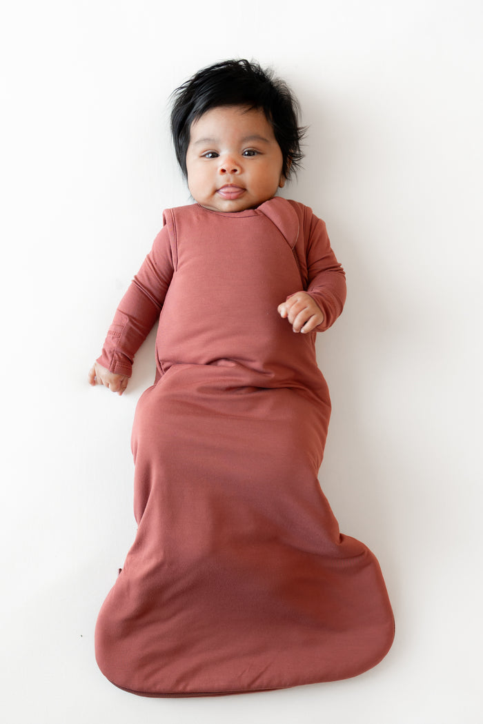 Baby in Sleep Bag in Ember 1.0 on a white background