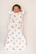 Baby sleeping in Sleep Bag in Halloween Teddy 1.0 print on a beige background