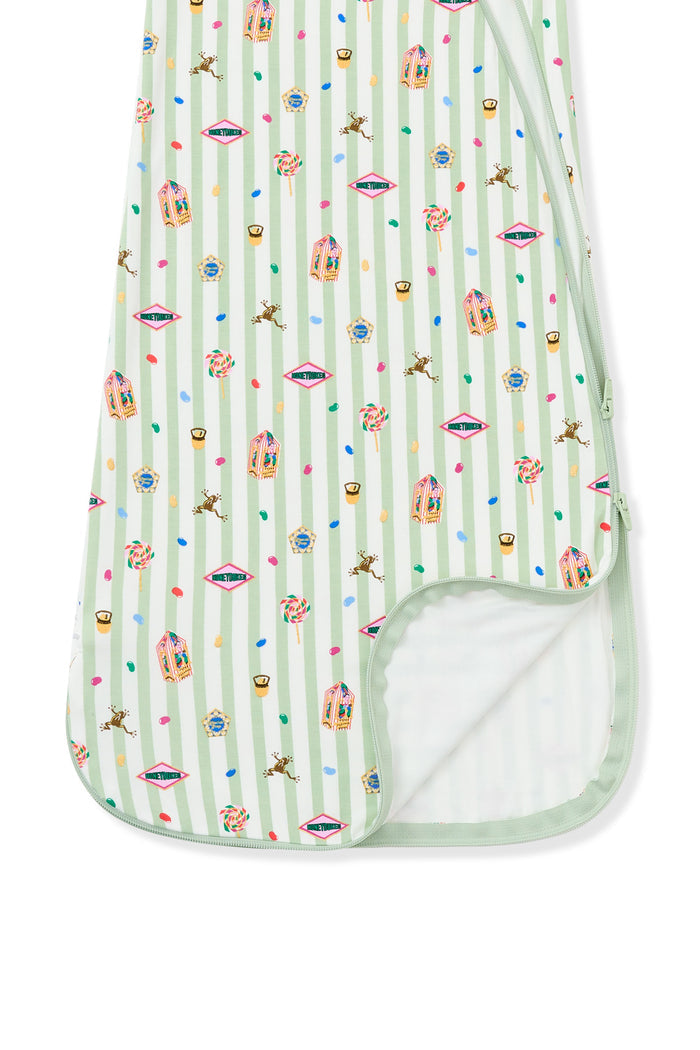 Bottom part of green and white striped sleep bag with colorful Harry Potter patterns on a white background