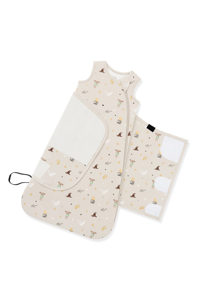 Adjustable swaddle wrap shown on an unswaddled beige Sleep Bag Swaddler in Harry potter print 1.0 on a white background
