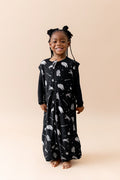Smiling girl wearing the Sleep Bag Walker in STAR WARS™ 1.0 with long sleeve black pajamas on underneath