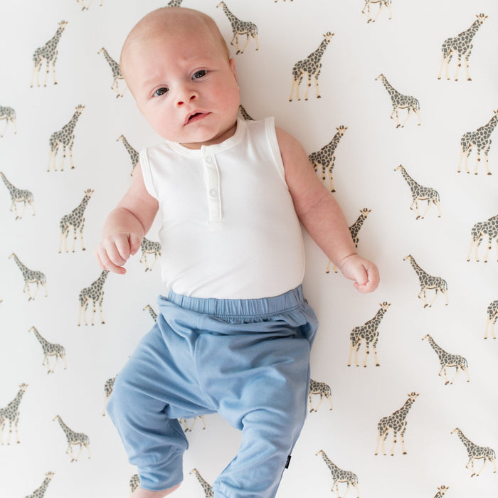 Infant wearing Kyte Baby Sleeveless Bodysuit in Cloud and Pants in Slate