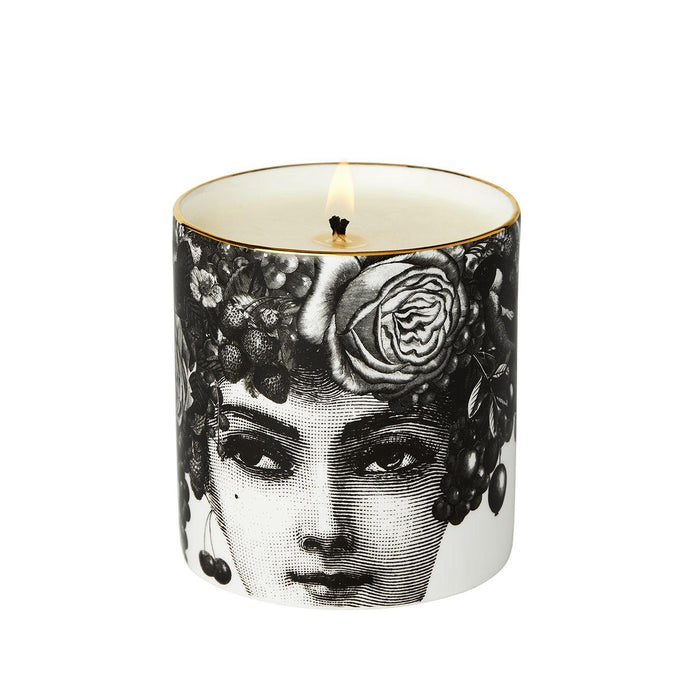 The Autumn Rose ceramic candle lit, showing the warm glow of the flame in the fine china vessel