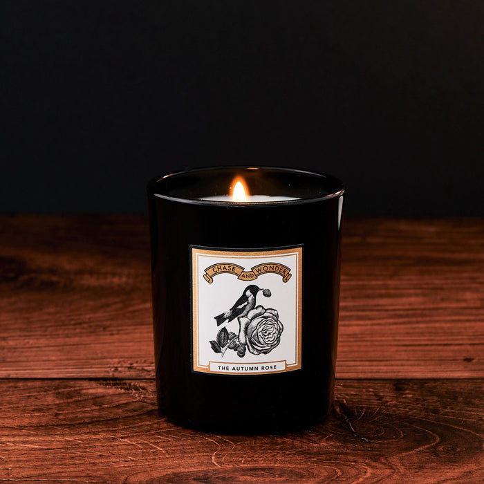 The Autumn Rose Luxury Scented Glass Candle by Chase and Wonder, elegant black glass vessel with gold lid
