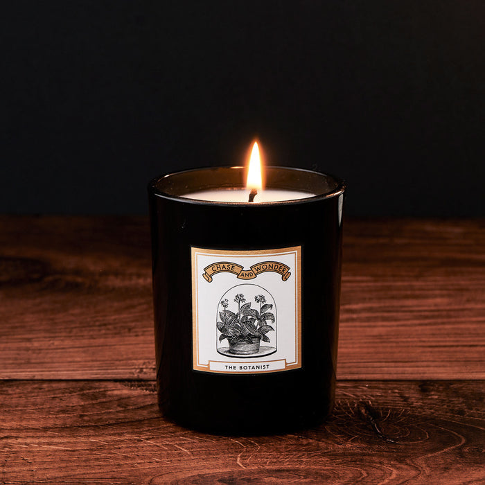 The Botanist Luxury Scented Glass Candle by Chase and Wonder, elegant black glass vessel with gold lid