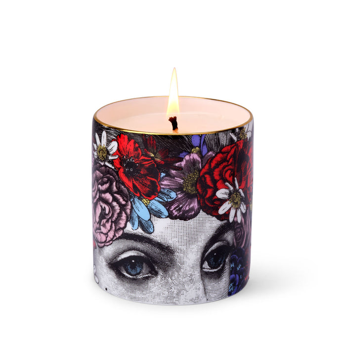 The Flower Lady Special Edition ceramic candle lit, showing the warm glow of the flame in the fine china vessel