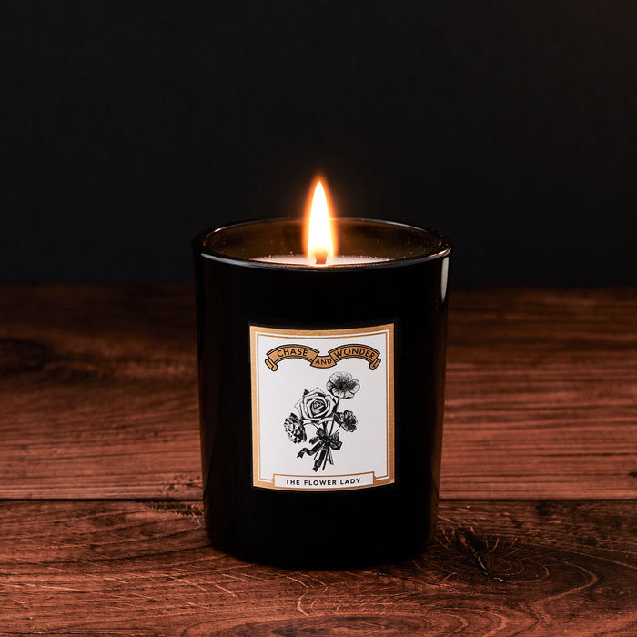 The Flower Lady Luxury Scented Glass Candle by Chase and Wonder, elegant black glass vessel with gold lid